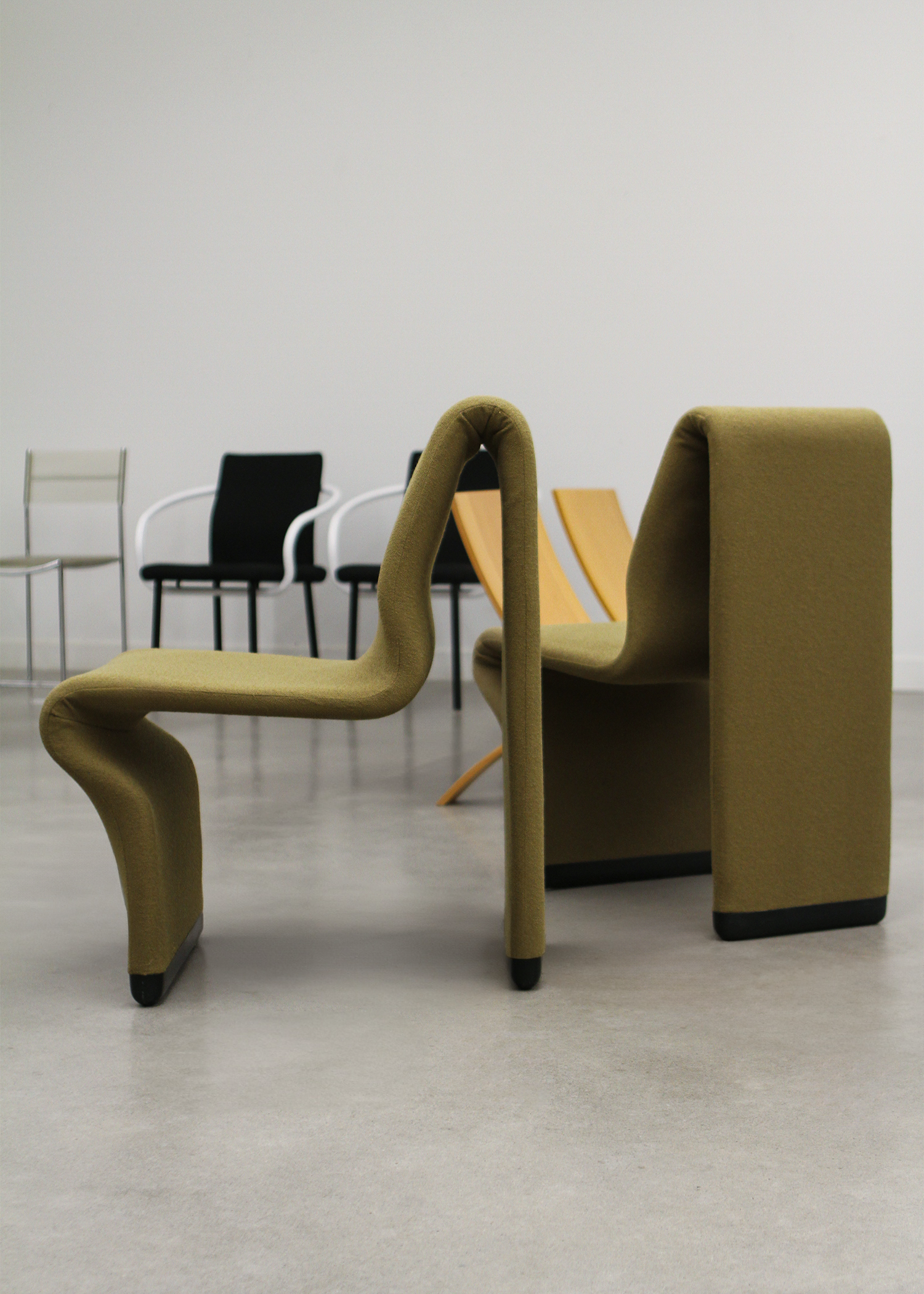 set of two postmodern abstract shaped vintage accent chairs by canadian designer paul boulva upholstered in a wool boucle in a chartreuse green. sold by mid century modern furniture consignment and restoration platform In Corso in Toronto Canada 