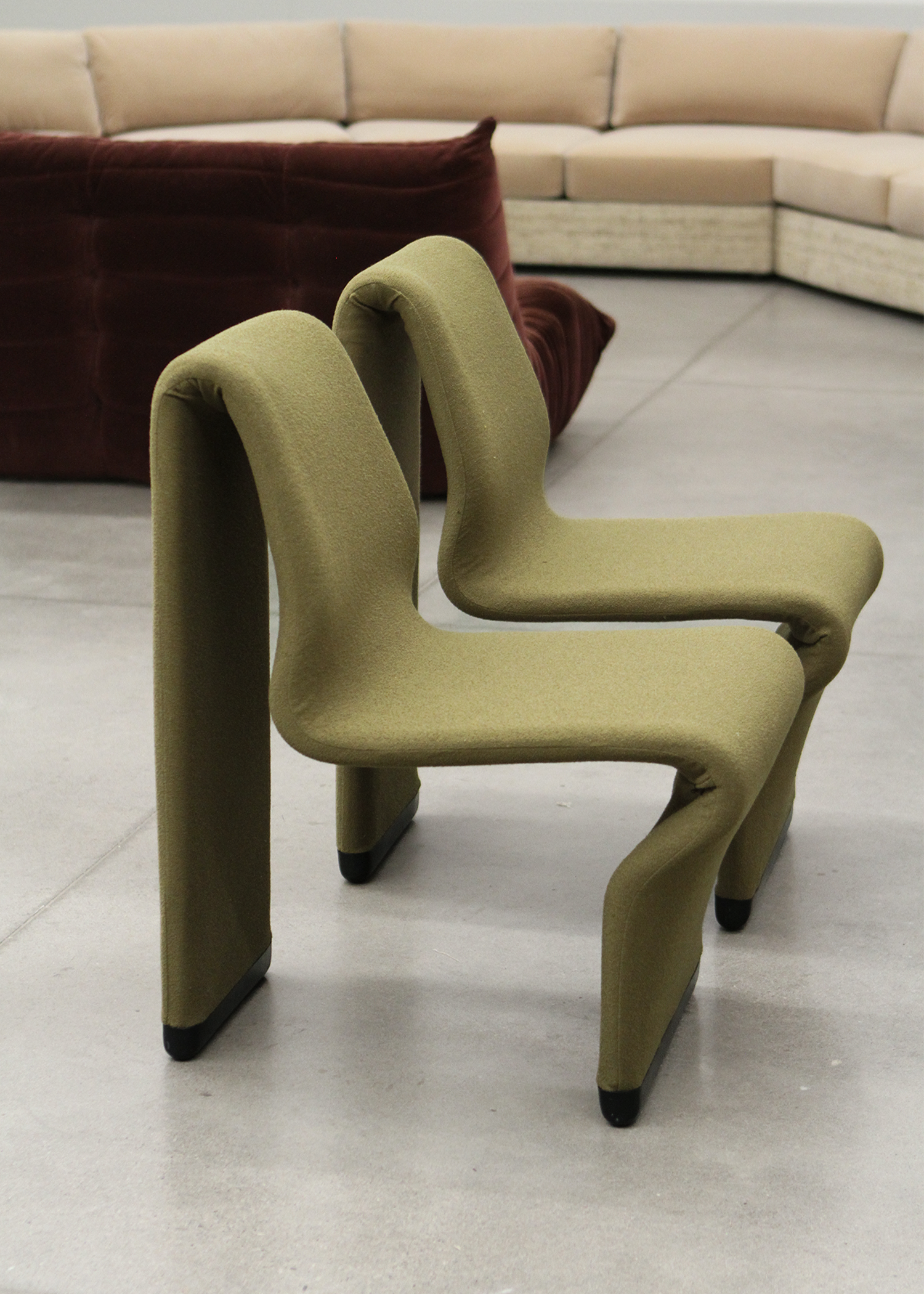 set of two postmodern abstract shaped vintage accent chairs by canadian designer paul boulva upholstered in a wool boucle in a chartreuse green. sold by mid century modern furniture consignment and restoration platform In Corso in Toronto Canada 