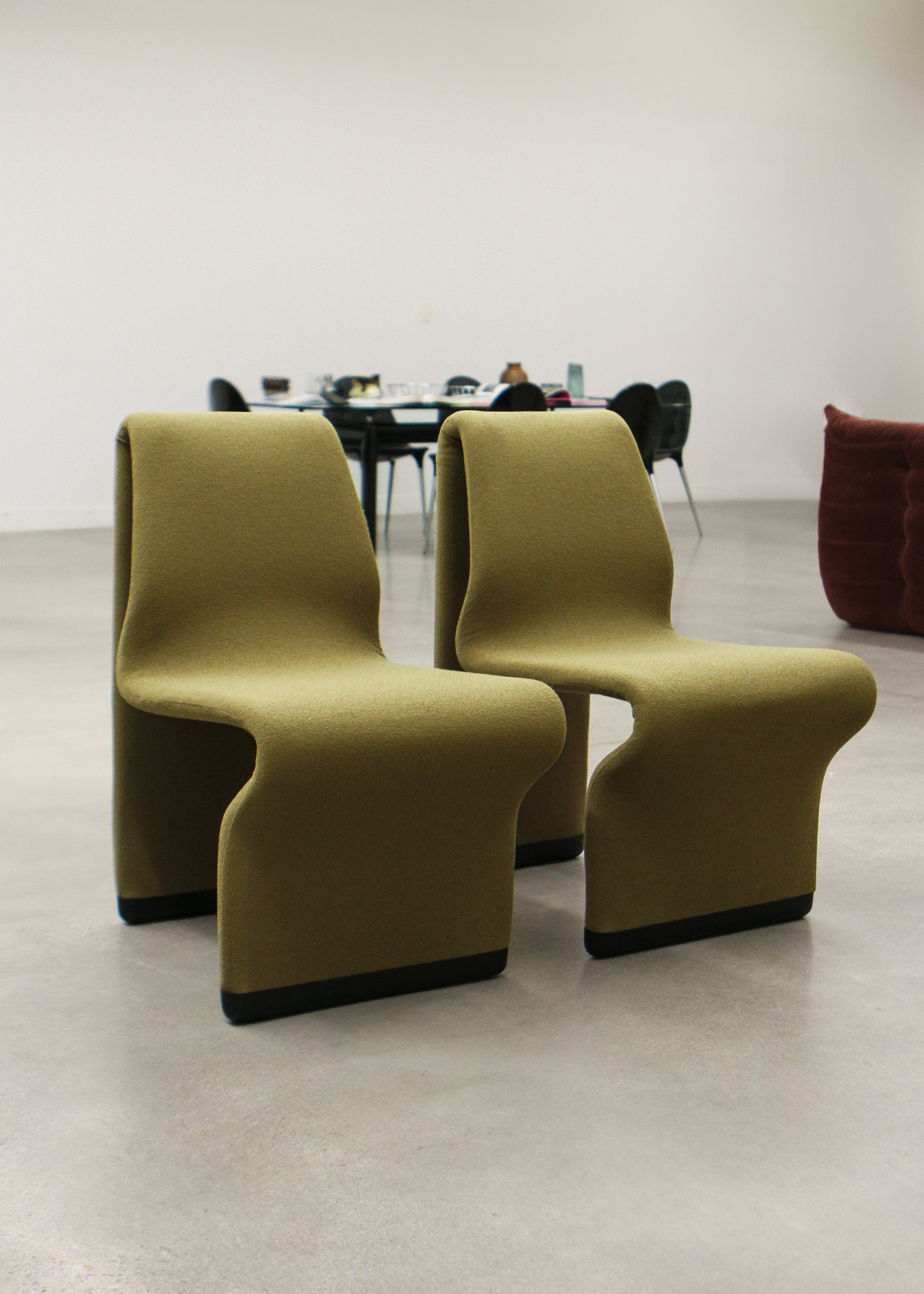set of two postmodern abstract shaped vintage accent chairs by canadian designer paul boulva upholstered in a wool boucle in a chartreuse green. sold by mid century modern furniture consignment and restoration platform In Corso in Toronto Canada 