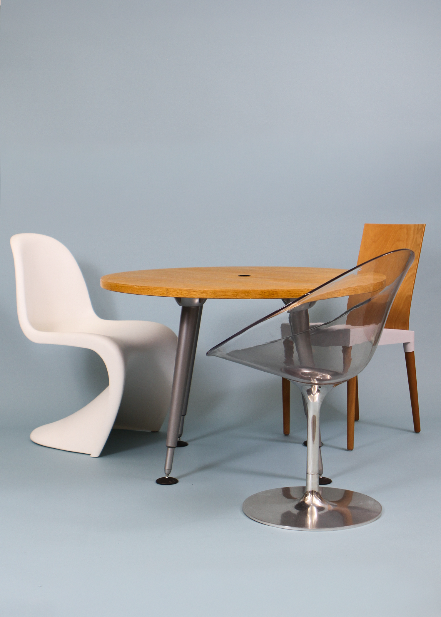 Adjustable round table with a warm wood veneer top and sculptural chrome legs that can be raised or lowered to suit your space. A versatile vintage piece that works as a compact dining table, statement side table, or elevated laptop station. Photographed on a neutral backdrop for clarity. Available at incorsostudio.com a vintage furniture platform in Toronto