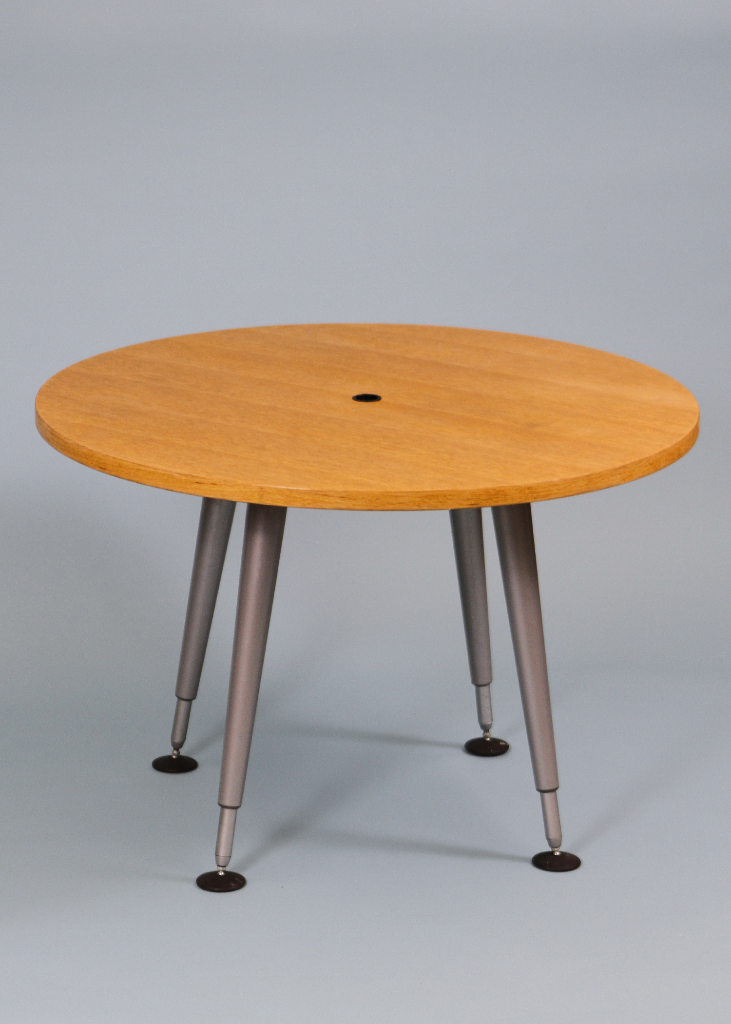 Adjustable round table with a warm wood veneer top and sculptural chrome legs that can be raised or lowered to suit your space. A versatile vintage piece that works as a compact dining table, statement side table, or elevated laptop station. Photographed on a neutral backdrop for clarity. Available at incorsostudio.com a vintage furniture platform in Toronto