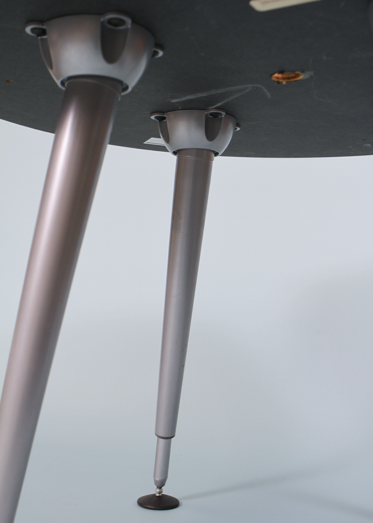 Adjustable round table with a warm wood veneer top and sculptural chrome legs that can be raised or lowered to suit your space. A versatile vintage piece that works as a compact dining table, statement side table, or elevated laptop station. Photographed on a neutral backdrop for clarity. Available at incorsostudio.com a vintage furniture platform in Toronto