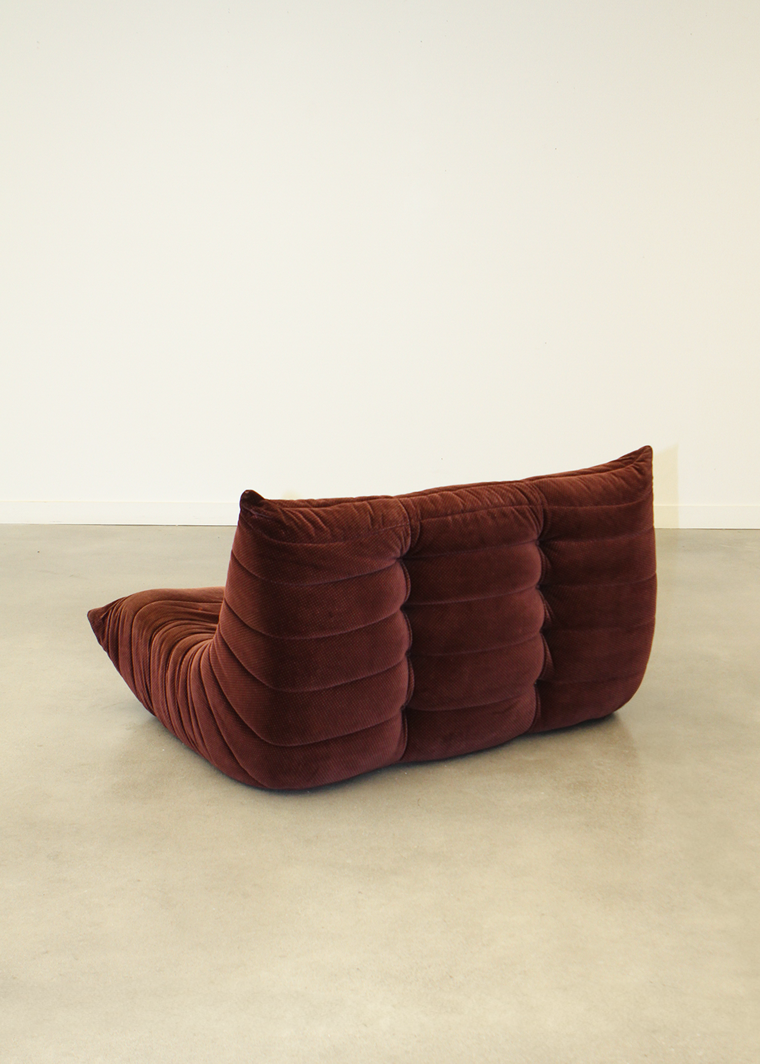 Togo love seat designed by Michel Ducaroy for Ligne Roset, produced under licence by Airborne/Arconas for the Canadian market under the Roset of France license.
Original velvet fabric in a deep purple/mauve colour is the perfect combination for a moody, low sofa such as this in a contemporary space. Sold by In Corso Studio a vintage furniture company specializing in rare mid century furniture in Toronto Canada